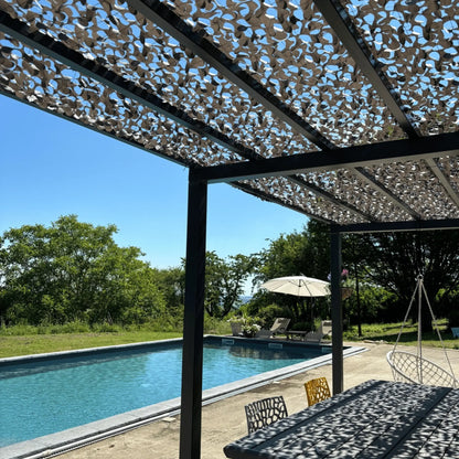 Filet de camouflage renforcé gris sur une pergola au bord de la piscine